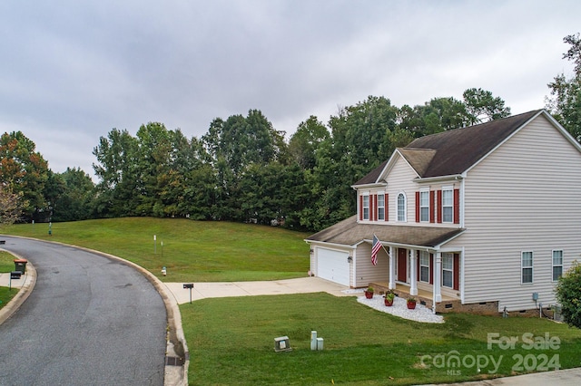 view of front of property with a garage and a front lawn