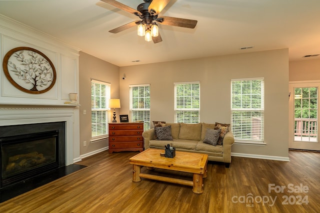 living room with ceiling fan and dark wood-type flooring