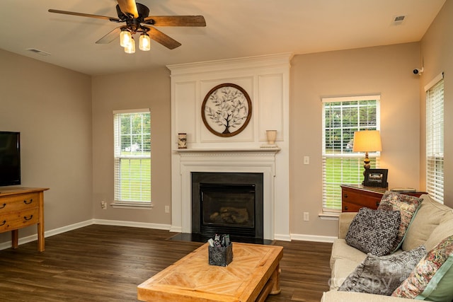 living room with ceiling fan and dark hardwood / wood-style floors