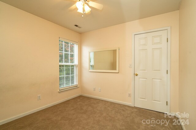 spare room with ceiling fan and carpet floors