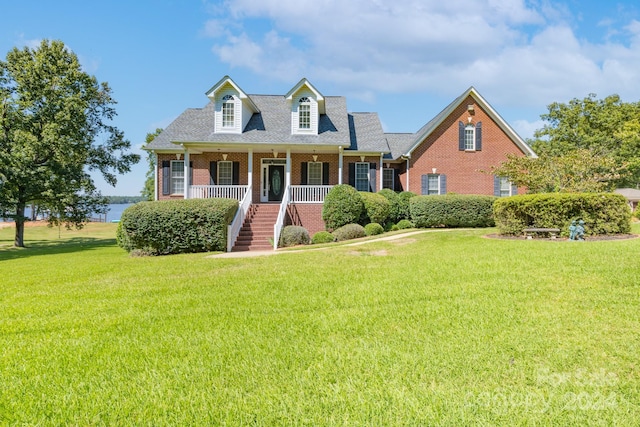 cape cod home with a porch and a front yard