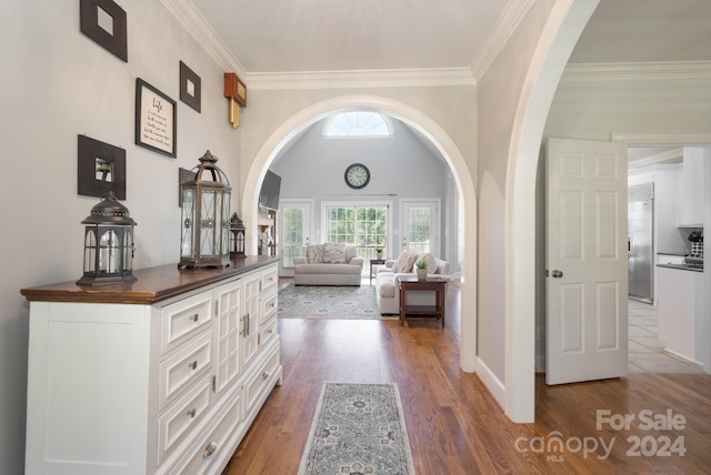 hallway with dark hardwood / wood-style floors and crown molding