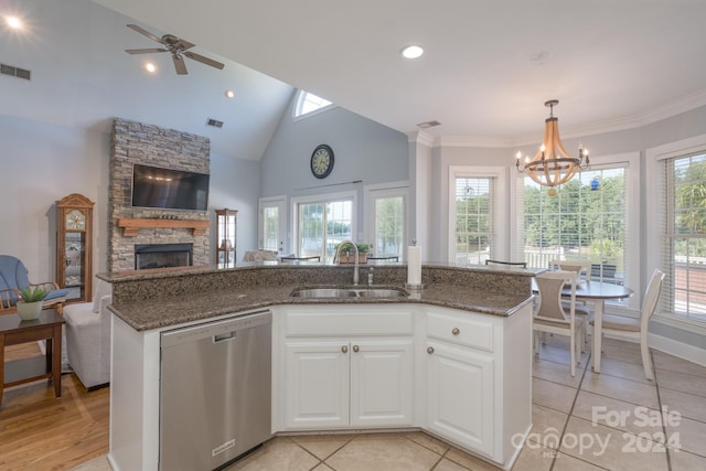 kitchen with a kitchen island with sink, stainless steel dishwasher, light hardwood / wood-style floors, and white cabinetry