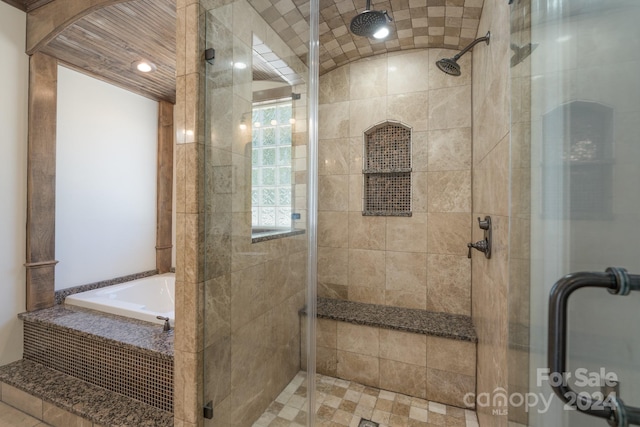 bathroom with tile patterned flooring and plus walk in shower