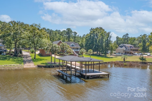 view of dock featuring a water view and a yard