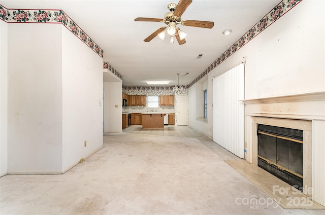 unfurnished living room with ceiling fan