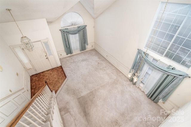 interior space with a towering ceiling and light parquet flooring