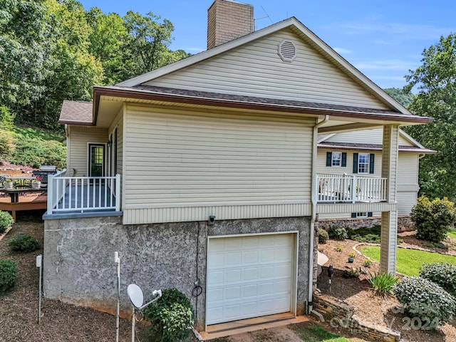 exterior space featuring a balcony and a garage