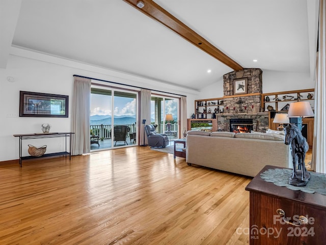 living room featuring a fireplace, lofted ceiling with beams, and light hardwood / wood-style floors