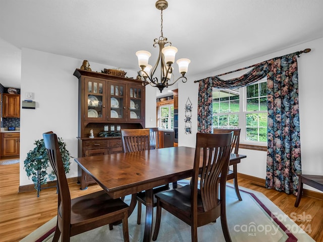 dining room featuring plenty of natural light, a chandelier, and light hardwood / wood-style floors