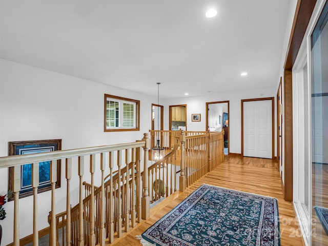 corridor with light hardwood / wood-style floors