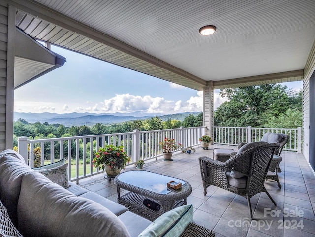 view of patio / terrace featuring an outdoor living space and a mountain view