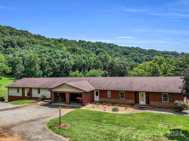 ranch-style home with a front yard and a carport