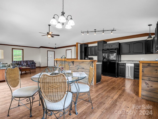 dining space featuring ceiling fan with notable chandelier, ornamental molding, wood-type flooring, and rail lighting