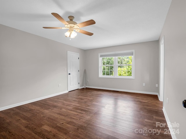 spare room with ceiling fan and dark hardwood / wood-style flooring