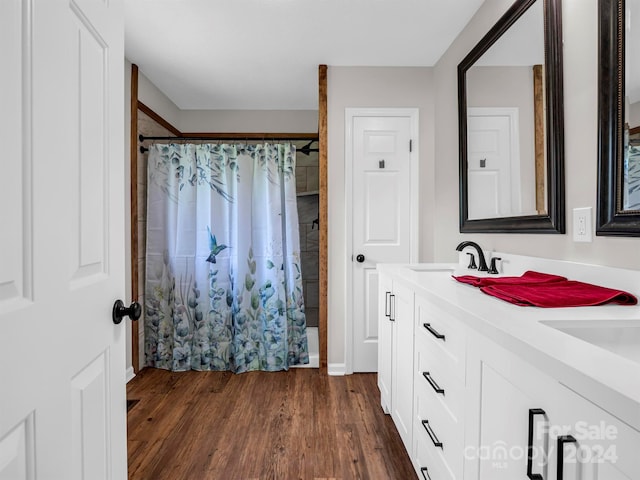 bathroom with vanity, curtained shower, and hardwood / wood-style flooring