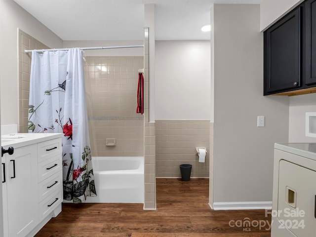 bathroom featuring washer / clothes dryer, wood-type flooring, shower / tub combo, and vanity