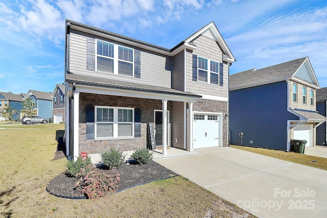 view of front of property with a front yard, a porch, and a garage