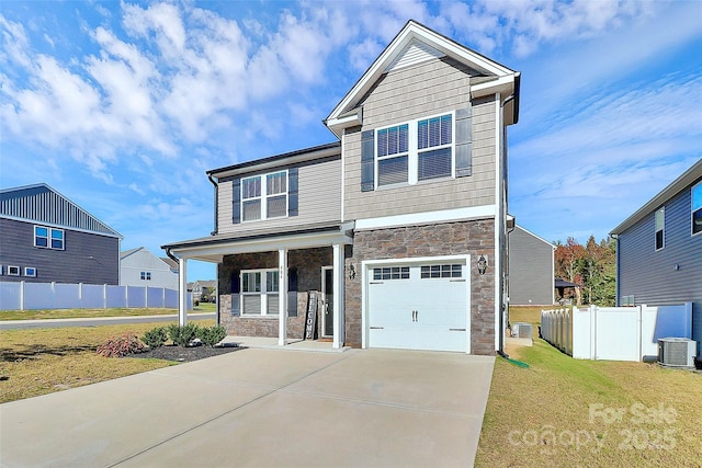 craftsman-style house featuring a front lawn, a garage, and central AC unit