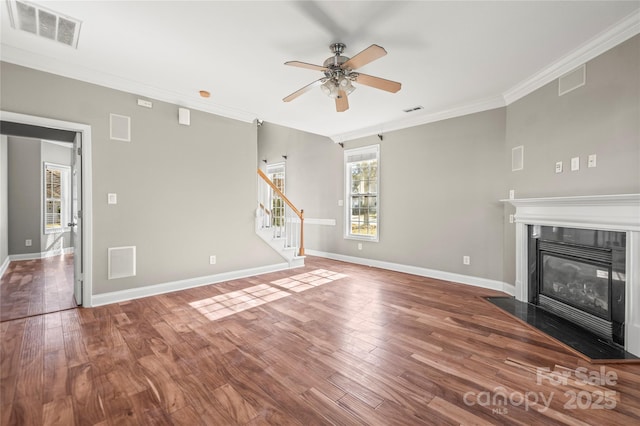 unfurnished living room featuring hardwood / wood-style flooring, ceiling fan, and crown molding