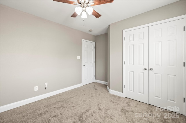 unfurnished bedroom with ceiling fan, a closet, and light colored carpet