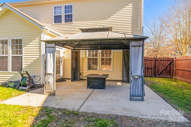 rear view of house with a gazebo and a patio