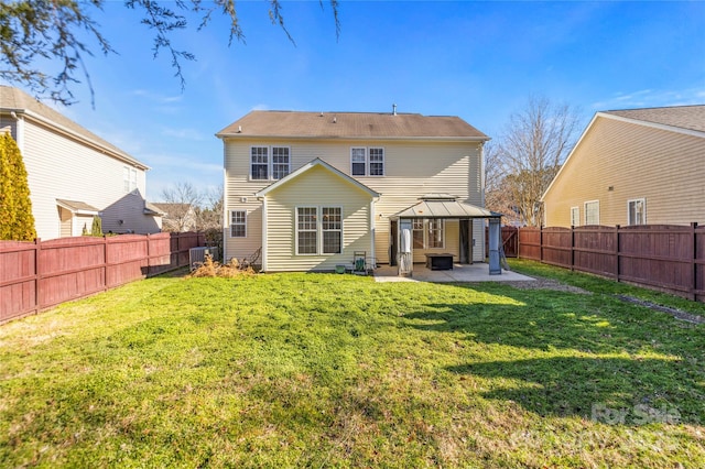 back of property featuring a gazebo, a yard, cooling unit, and a patio area