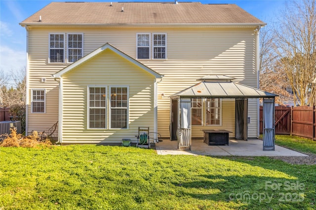 rear view of property featuring a gazebo, a yard, a patio, and central AC