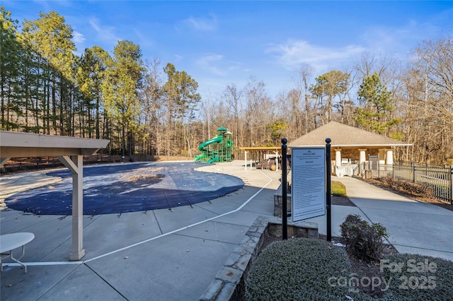 view of swimming pool with a playground