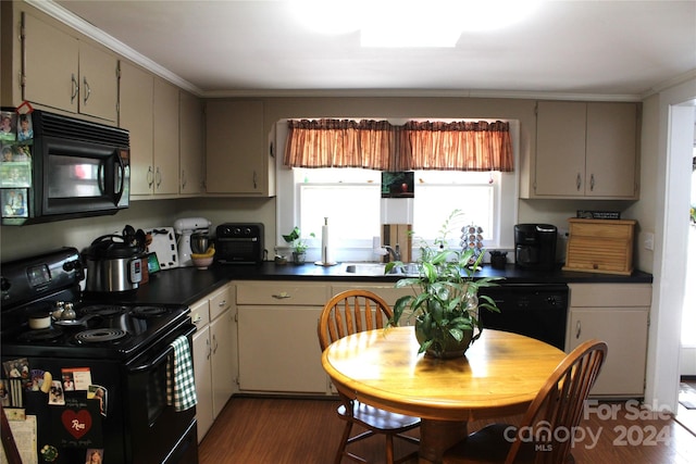 kitchen with dark hardwood / wood-style flooring, black appliances, sink, and crown molding