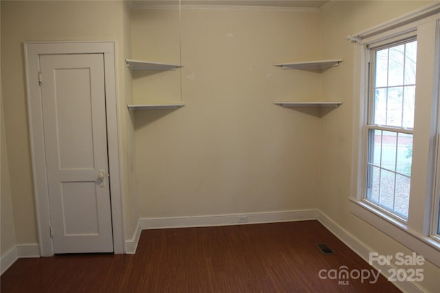 interior space with dark hardwood / wood-style flooring and crown molding