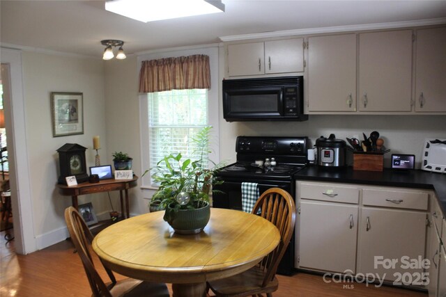 kitchen with gray cabinets, ornamental molding, light hardwood / wood-style flooring, and black appliances