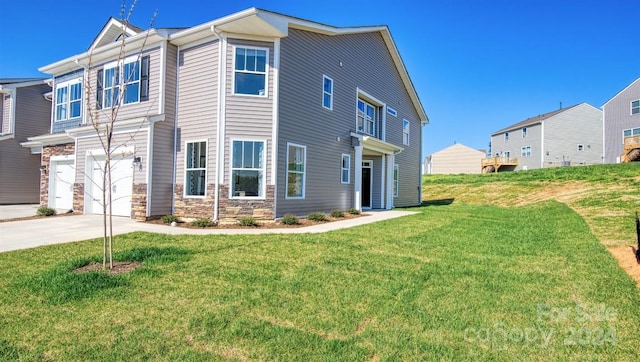 view of front facade with a front yard and a garage