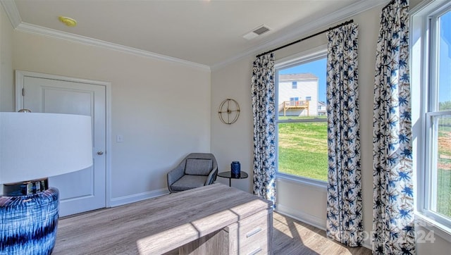 bedroom with light wood-type flooring, crown molding, and multiple windows