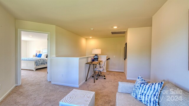 interior space with a kitchen breakfast bar and light carpet