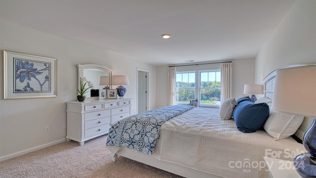 bedroom featuring light carpet