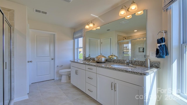 bathroom featuring toilet, vanity, tile patterned flooring, and an enclosed shower