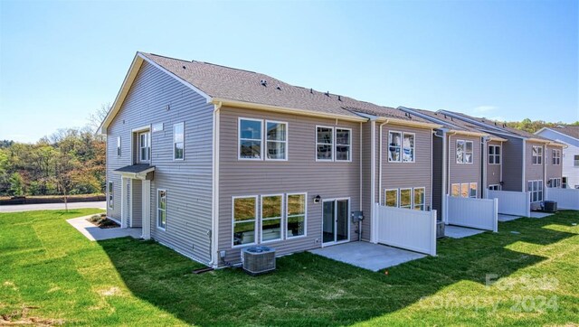 rear view of house featuring a yard and a patio