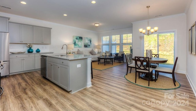 kitchen with gray cabinets, ornamental molding, light hardwood / wood-style floors, a notable chandelier, and stainless steel appliances