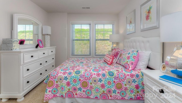 carpeted bedroom with multiple windows