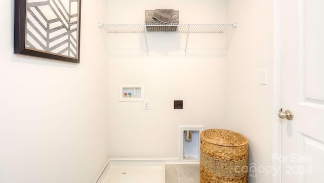 laundry area featuring hookup for a washing machine, electric dryer hookup, and tile patterned flooring