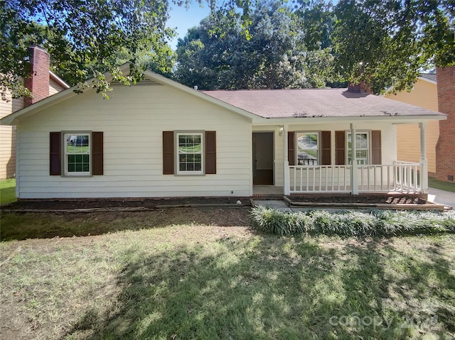 ranch-style home with covered porch and a front yard