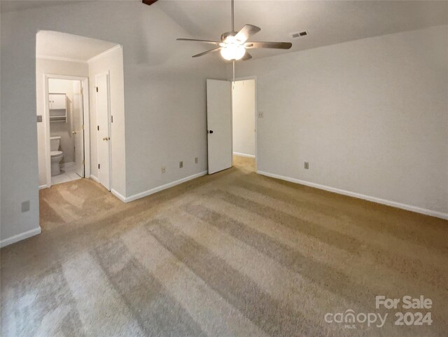 carpeted empty room with ceiling fan and vaulted ceiling