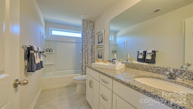 full bathroom featuring washtub / shower combination, vanity, toilet, and tile patterned floors