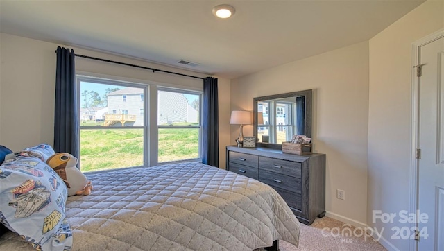 bedroom with light colored carpet