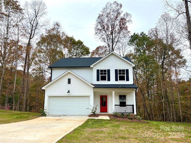 view of front facade with a front lawn, covered porch, and a garage