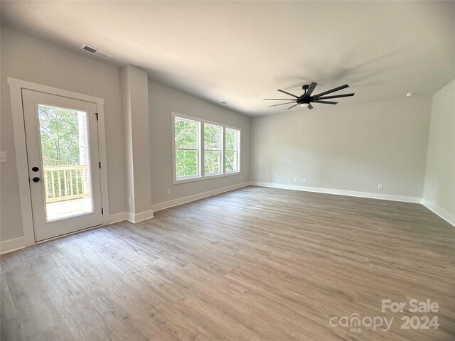 empty room featuring ceiling fan and light wood-type flooring