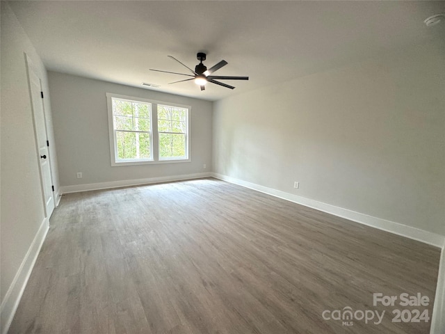 unfurnished room with hardwood / wood-style floors and ceiling fan