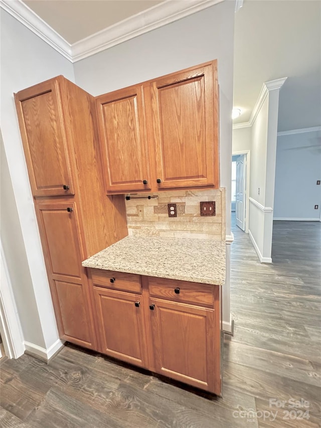 kitchen featuring ornamental molding, decorative backsplash, and dark wood finished floors