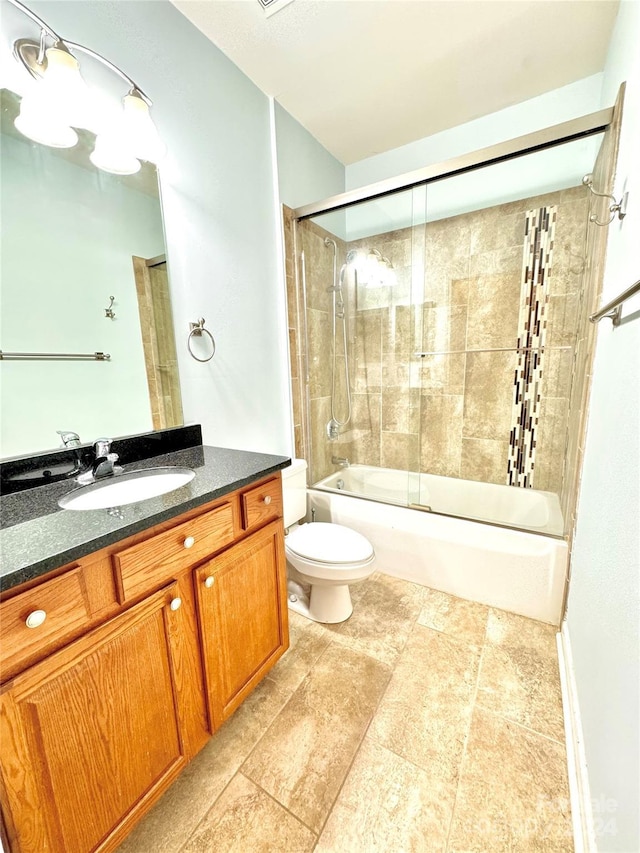 full bathroom with enclosed tub / shower combo, vanity, and toilet